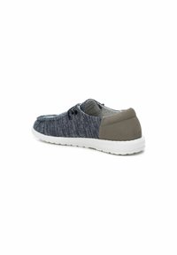 Zapatilla casual con parte superior de punto en marino, acento en el talón gris y suela de goma blanca. Presenta cordones negros y forro interior a rayas.
