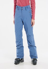 Blue ski pants made of waterproof material feature a straight leg design, two zippered pockets, and a high waistband with button accents.