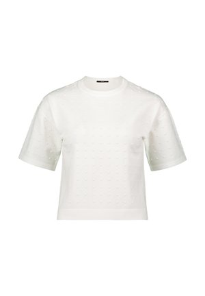 White short-sleeve top featuring a textured pattern of small raised dots, round neckline, and a boxy silhouette. Soft fabric with a smooth finish.