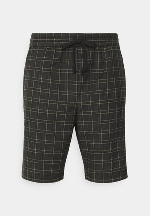 Shorts à carreaux noirs avec taille élastiquée et cordon de serrage, présentant un motif quadrillé beige. Confectionnés dans un tissu léger, longueur jusqu'au genou.