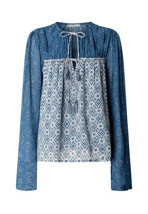 Blauw-witte blouse met lange mouwen en geometrische patronen, voorzien van twee gebonden tassel-lintjes bij de halslijn en midden op de borst.