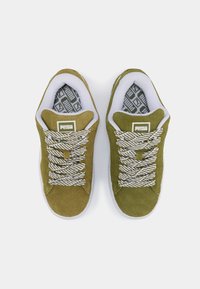 Baskets en suède vert olive avec un liseré blanc, semelle extérieure en caoutchouc texturé et lacets à motifs. Patch logo sur la languette ; intérieur doux et rembourré.