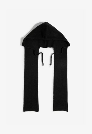 Sort strikket hætte med lange, tynde tørklignende forlængelser. Har en spids top og snore til sikker pasform. Blød tekstur med ribbet mønster.