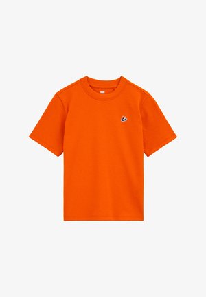 Prosty, jasnopomarańczowy, bawełniany T-shirt z krótkim rękawem, z małym niebiesko-białym logo ptaka na lewej piersi.