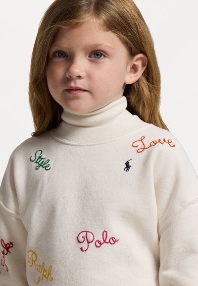 Sweatshirt creme com um decote alto, apresentando texto bordado multicolorido e um pequeno logótipo bordado no peito.