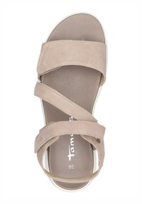 Beige suede sandal with three diagonal straps, padded insole, and white rubber sole. Brand name "Tamaris" embossed on the strap. Size 38.