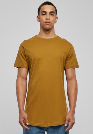Mustard yellow cotton t-shirt with a crew neckline and short sleeves. Straight hem at the waist, smooth texture, and minimal design.