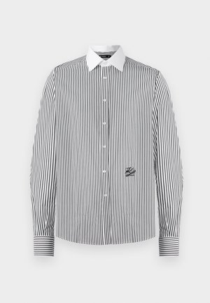 Črna in bela črtasta srajca s kratkimi rokavi, z belim ovratnikom, z majhnim črnim logotipom na levi strani in črtastimi manšetami.