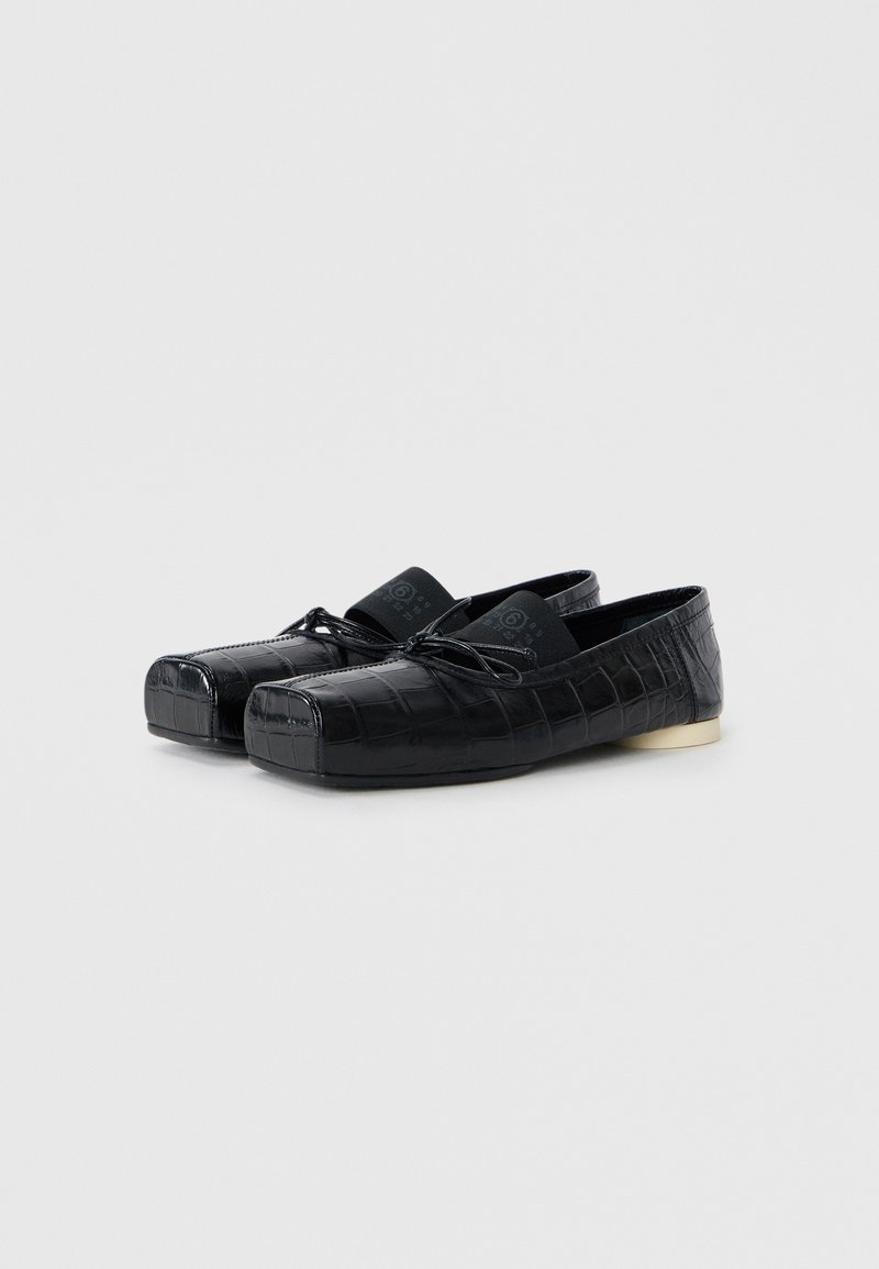 Black shoes with a glossy crocodile pattern, rounded toe, lace detail, and a small gold heel accent. Soft fabric lining visible inside.