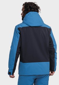 Blaue und schwarze wasserdichte Jacke mit Kapuze, ausgestattet mit einem Farbabstufungsdesign, glatter Stoffoberfläche und verstellbaren Bündchen.