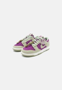 Sneakers with purple and light grey suede upper, featuring textured fabric, lace-up design, and a rubber sole with green accents.