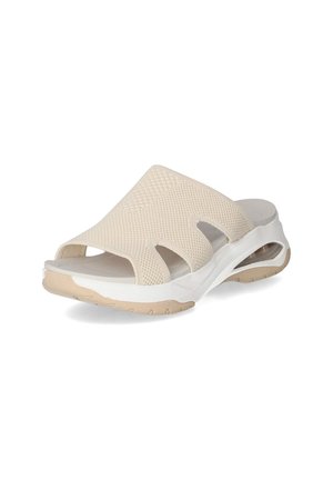 Beige slip-on sandal with a mesh upper, open design, and white sole. Features cut-out sections and textured surface for breathability.