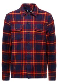 Giacca a camicia a quadri in navy, rosso e arancione. Presenta una chiusura con bottoni, due tasche sul petto e maniche lunghe con polsini abbottonati. Materiale misto lana.