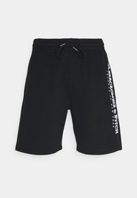 Pantaloni corti neri in cotone, con vita regolabile tramite un laccetto e dettagli del logo laterali bianchi. Design semplice con texture liscia.