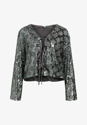 Lühikeste varrukatega crop top, valmistatud mustast ja hõbedasest sädelevast kangast. Omab V-kaelust ja esimest sidumist, millel on satiinist detailid.