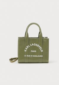 Small olive green handbag with two handles, a shoulder strap, and white text reading "KARL LAGERFELD PARIS 21 RUE ST-GUILLAUME" on front.