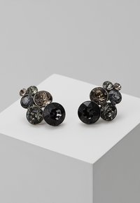 Boucles d'oreilles rondes présentant un cluster de cristaux étincelants dans des nuances de noir, gris et taupe, montés sur une base métallique argentée.