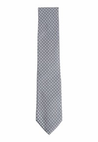 Cravate en soie avec un motif ovale répétitif en bleu, rose et blanc. Extrémité étroite et pointue avec une texture lisse.