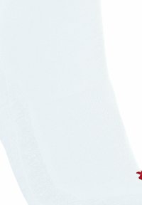 Chaussette de sport blanche avec une texture côtelée, présentant un petit logo rouge près de la base. L'accent est mis sur le matériau et le design de la chaussette.