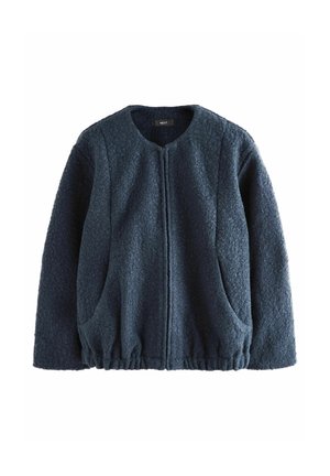 Veste polaire texturée bleu foncé à manches longues, col rond, fermeture éclair devant, deux poches latérales et bas élastiqué.