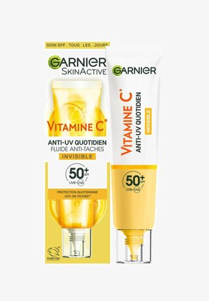 Crème solaire Garnier Vitamine C SPF 50+, dans un tube blanc et jaune, avec un capuchon transparent et un design mettant en avant la protection UV et les propriétés anti-imperfections.