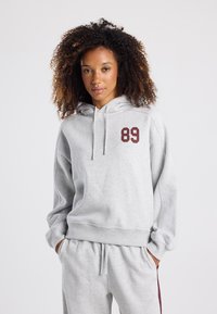 Light gray hoodie in cotton blend, featuring a front pocket, drawstring hood, and a burgundy number "89" on the left chest.