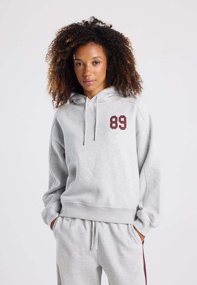Light gray hoodie in cotton blend, featuring a front pocket, drawstring hood, and a burgundy number "89" on the left chest.