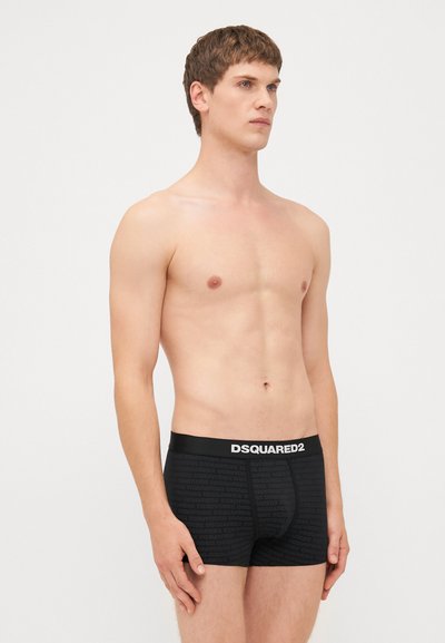 Black boxer briefs with a logo-accented waistband and subtle repeating text pattern. Made from stretchy, smooth fabric for comfort.