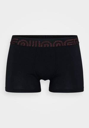 Schwarze Boxershorts mit taillierter Passform, ausgestattet mit einem dunkel gemusterten Bund und glatter Textur. Die Akzente sind minimal gehalten mit flachen Nähten.