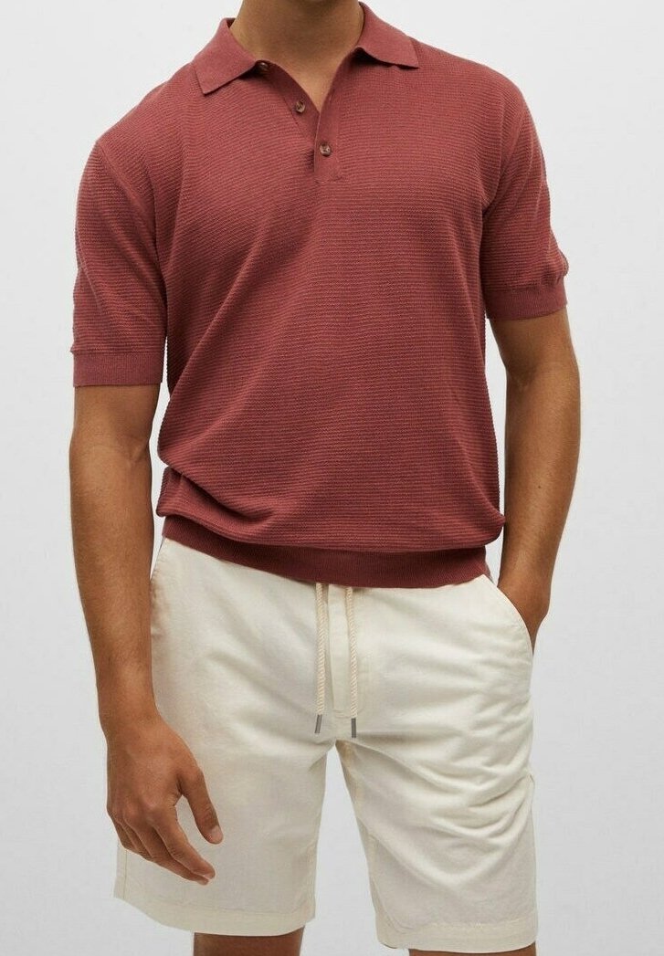 Polo marron à manches courtes avec un motif texturé, doté d'une patte à trois boutons ; accompagné d'un short beige clair.