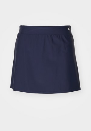 Jupe-culotte bleu marine avec une texture lisse, un design évasé et une taille élastique. Comprend un petit accent métallique sur la taille.