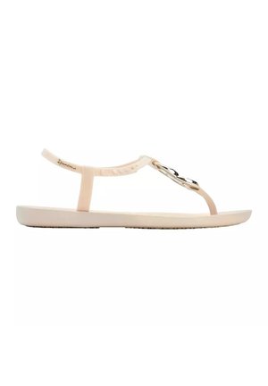 Sandali piatti di colore rosa chiaro con design a T-strap. Realizzati in materiale morbido, presentano un accento decorativo metallico e una suola texturizzata.