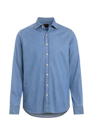Ljusblå denimskjorta med spetsig krage, långa ärmar och framknäppning. Har en rundad fåll och subtil textur.