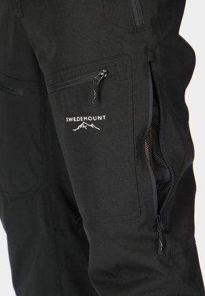 Black outdoor pants made of durable material featuring zipper pockets and an embroidered logo above the right pocket.