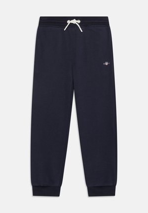 Marineblaue Jogginghose mit Kordelzug an der Taille, gerippten Bündchen und kleinem Logo am linken Oberschenkel, aus weichem Baumwollmischgewebe gefertigt.