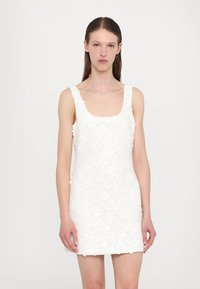 White sleeveless dress featuring a textured floral pattern, square neckline, and fitted silhouette. Short length with a smooth finish.