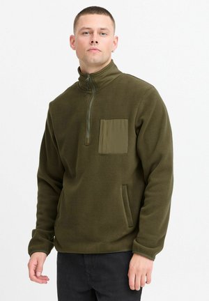Olive green fleece pullover with a quarter zip and a chest pocket. Features soft texture and side pockets, designed for comfort.