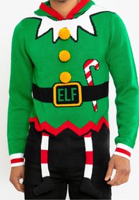 Pull en tricot vert avec des accents rouges, présentant un design d'elfe, des boutons en pompon, des détails en canne de bonbon et des chaussettes suspendues à la taille.