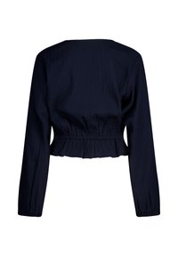 Navy blue cropped top with long sleeves, featuring a textured fabric, elasticated waistband, and ruffled hem. No visible fastenings.