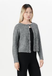 Gray knitted cardigan with a round neckline, button-front closure, two front pockets, and textured fabric. Cropped length and long sleeves.