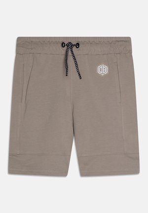 Beige shorts med elastisk talje, sort og hvid snor, sidelommer og et lille hvidt hexagonalt logo på højre forside.