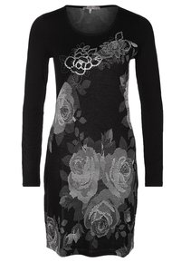 Robe noire à manches longues avec un motif floral argenté en sequins. Fabriquée en tissu léger, elle présente un col rond et une coupe ajustée.