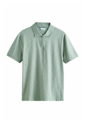 Lysegrøn kortærmet polo med tekstureret bølgemønster og frontlynlås under kraven.