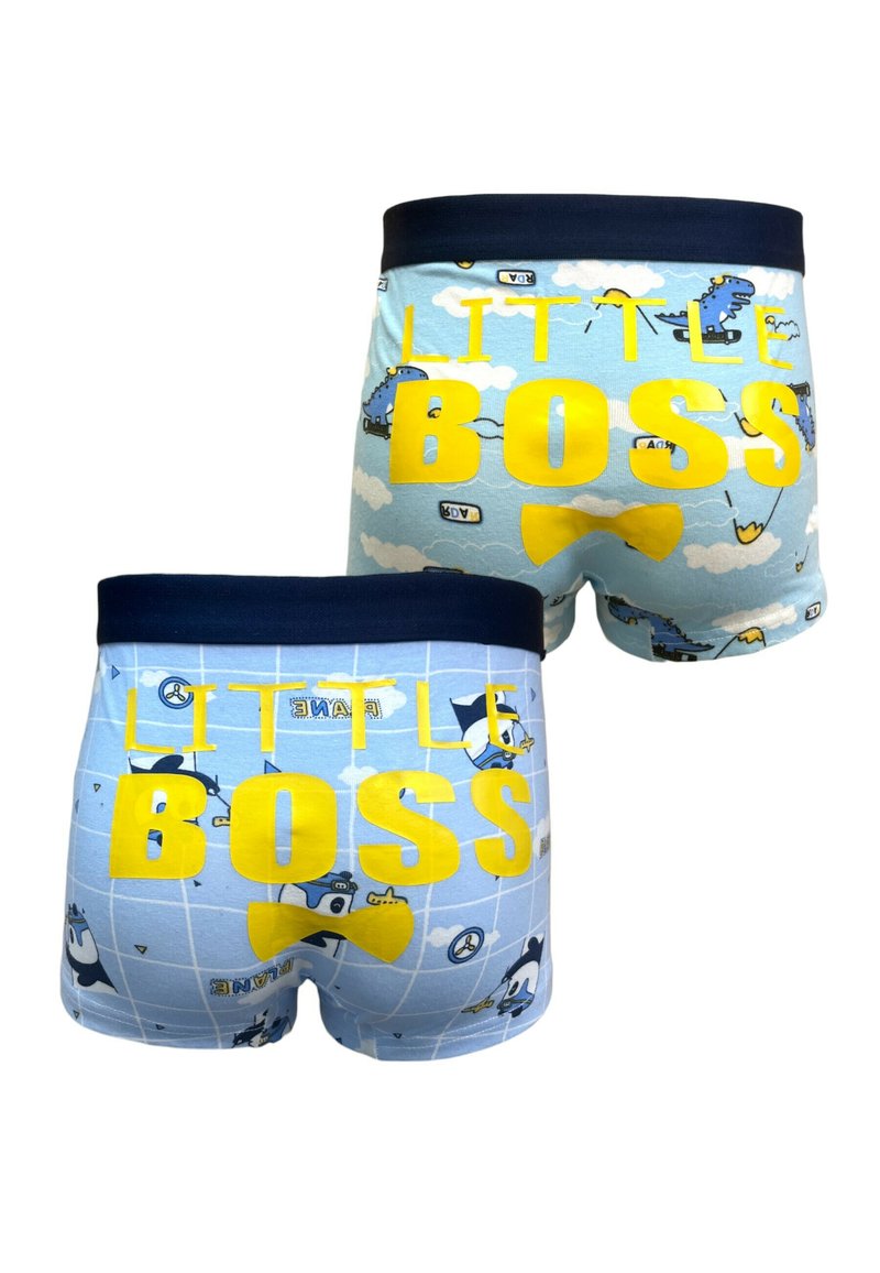Boxer shorts en coton bleu avec le texte "PETIT PATRON" en jaune, illustrés avec des avions et des nuages de style cartoon, et une taille en marine.