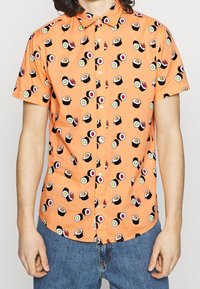 Short-sleeve button-up shirt in orange fabric, featuring a repeated sushi print in various colors. Relaxed fit with a classic collar.