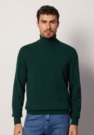 Dunkelgrüner Rollkragenpullover aus weichem Strickmaterial. Hat lange Ärmel und gerippte Bündchen, mit einer figurbetonten Passform und ohne sichtbare Muster.