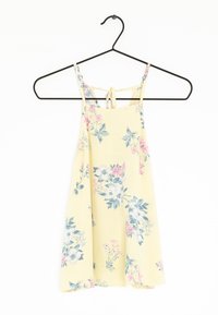 Sukienka w kwiaty w jasnożółtym kolorze, wykonana z materiału, z wielokolorowymi wzorami kwiatowymi, regulowanymi ramiączkami i wiązaniem z tyłu. Idealna na ciepłe dni.