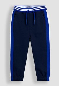 Pantaloni jogger de culoare bleumarin cu manșete elastice, buzunare laterale, brâu cu dungi albastre și albe și dungi albastre și albe pe lateral.
