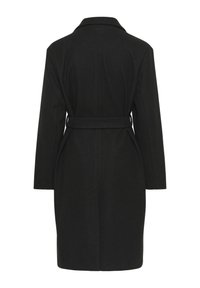 Manteau en laine noir avec une coupe droite, col cranté, manches longues et taille ceinturée. Présente un dos uni sans embellissements.