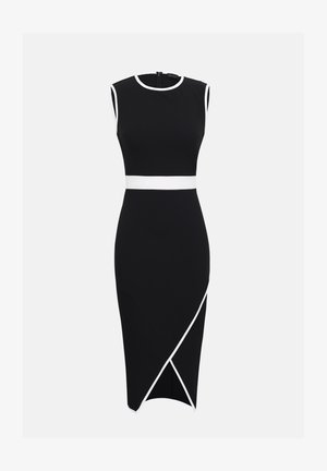 Hihaton musta midimekko, jossa valkoiset reunukset pääntiellä, kainaloissa, vyötäröllä ja hameen etuosan vino leikkaus yksiväristä taustaa vasten.